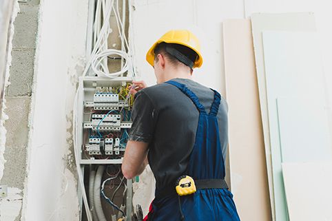 Technician working with wire at switcher